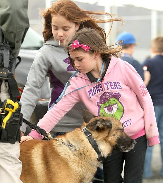 K-9 Deputy Ary enjoys a back scratch from Boys &amp; Girls Clubs members Nina Sapien, 10, and Kaitlyn Kohls, 8, at the clubs&#039; &quot;Celebrate Our Heroes Day&quot; on Tuesday.