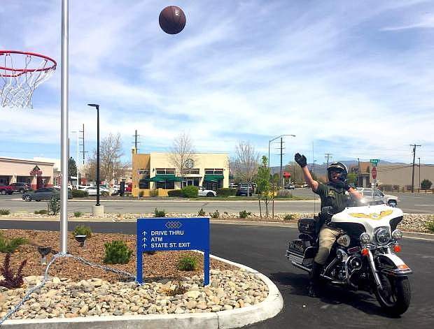 A Carson City deputy takes a shot on Tuesday at the United Federal Credit Union&#039;s grand opening &quot;Shoot a Hoop for a Cause&#039;&quot; fundraiser to benefit the Boys and Girls Clubs of Western Nevada. The fundraising event will continue through Thursday.