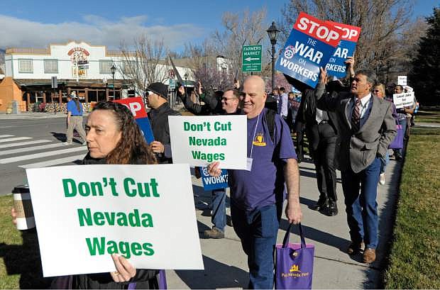 FILE - In this March 12, 2015, file photo, about 100 people rally in front of the Nevada Legislative Building and Capitol in Carson City, Nev. People at the event, organized by the AFL-CIO, were protesting what they say is a constant attack on workers since Republicans took control of the Nevada Legislature. At a rally a week later, a woman yelled to a crowd of union workers in front of the Nevada Capitol, screaming until her voice broke for the governor to &quot;quit attacking us&quot; and rallying attendees to &quot;stand up, fight back!&quot; But Gov. Brian Sandoval didn&#039;t come out, and a bevy of bills to weaken collective bargaining and restructure public employee pensions remain on the agendas--including one scheduled for a hearing Wednesday, March 25, that labor groups call the &quot;Union Armageddon Bill.&quot; (AP Photo/Lisa J. Tolda, File).
