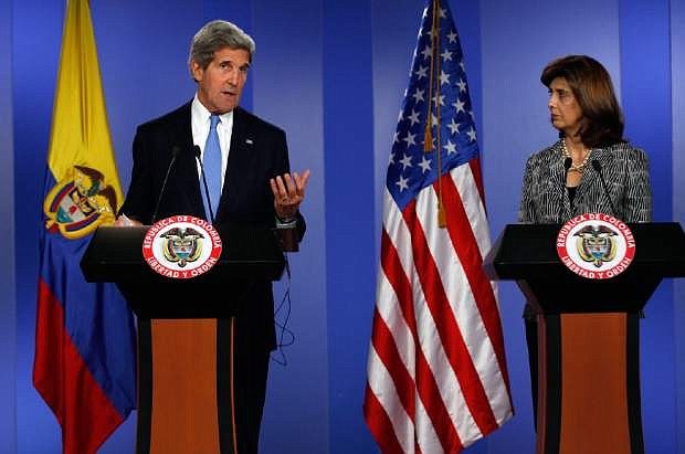 U.S. Secretary of State John Kerry, left, speaks as Colombia&#039;s Foreign Minister Maria Angela Holguin looks on during a joint news conference at the Presidential Palace in Bogota, Colombia, Monday, Aug. 12, 2013. Kerry is on a one-day official visit to Colombia. (AP Photo/Fernando Vergara)