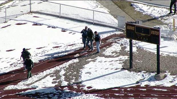 In this still image taken from video provided by Fox 31 Denver, police respond to reports of a shooting at Arapahoe High School in Centennial, Colo. Friday, Dec. 13, 2013. Colorado division of emergency management spokeswoman Micki Trost said her director went to the school and their weren&#039;t any more immediate details. (AP Photo/KDVR) MANDATORY CREDIT