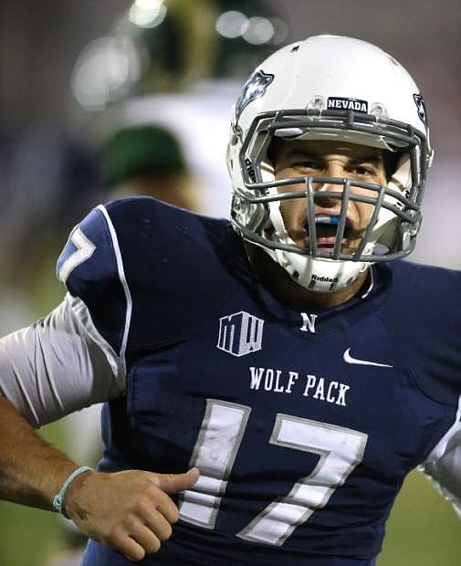 Nevada quarterback Cody Fajardo (17) celebrates a touchdown against Colorado State during the first half of an NCAA college football game in Reno, Nev., on Saturday, Oct. 11, 2014. Colorado State won 31-24. (AP Photo/Cathleen Allison)