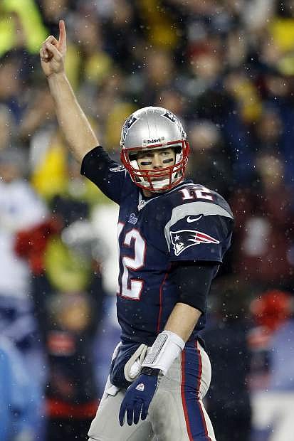New England Patriots quarterback Tom Brady celebrates running back Stevan Ridley&#039;s touchdown during the second half of an AFC divisional NFL playoff football game against the Indianapolis Colts in Foxborough, Mass., Saturday, Jan. 11, 2014. (AP Photo/Michael Dwyer)