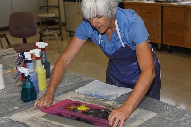 Tina Drakulich demonstrates pulp printing with a stencil on Wednesday at WNC. She is part of DJD&#039;s Art Combat Paper Nevada Project which re-purposes military uniforms and other cloth items into paper.
