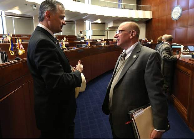 Nevada Republican Sens. James Settelmeyer, left, and Joe Hardy talk on the Senate floor at the Legislative Building in Carson City, Nev., on Monay, March 25, 2013. Both lawmakers introduced bills related to concealed weapon permits Monday, Hardy&#039;s bill would allowing school employees with concealed weapon permits to carry guns on campus and Settelmeyer&#039;s would allow people with permits to have it listed on their driver&#039;s license. (AP Photo/Cathleen Allison)
