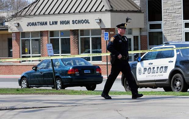 Police remain on scene at Jonathan Law High School after a 16-year-old girl was stabbed to death in Milford, Conn., Friday, April 25, 2014. A teenage boy is in custody, and police are investigating whether the attack stemmed from her turning down an invitation to be his prom date. (AP Photo/The New Haven Register, Peter Hvizdak) MANDATORY CREDIT