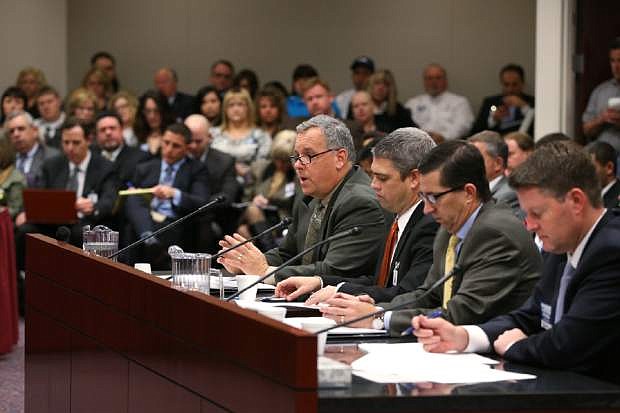 Construction industry representatives testify before a joint judiciary committee at the Legislative Building in Carson City, Nev., Wednesday, Feb. 11, 2015. The hearing drew large crowds as lawmakers work to curb frivolous construction defect lawsuits. (AP Photo/Cathleen Allison)