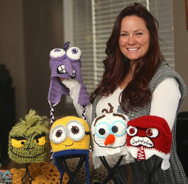 Dayton resident Katy Gardner displays some of the winter hats that she crochets by hand.