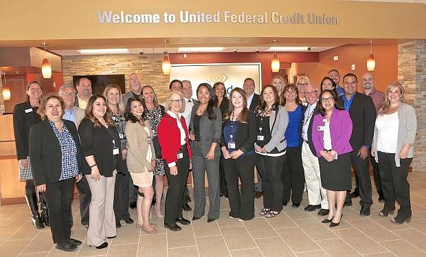 United Federal Credit Union employees, management and city dignitaries pose for a photo at the grand opening of the branch Thursday on William Street in Carson City.