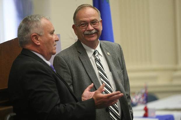 Bernie Curtis listens while Public Safety Director Jim Wright tells a story during Curtis&#039; retirement party on Wednesday at the capitol.