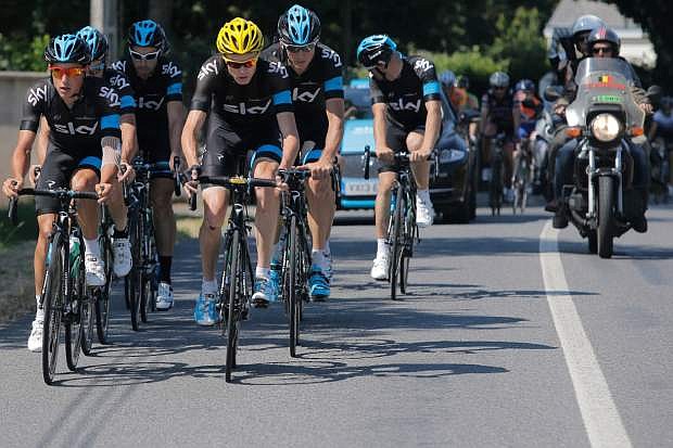 Overall leader Christopher Froome of Britain, with yellow helmet, trains with his teammates on the rest day of the Tour de France cycling race in La Baule, western France, Monday July 8 2013. (AP Photo/Laurent Cipriani)