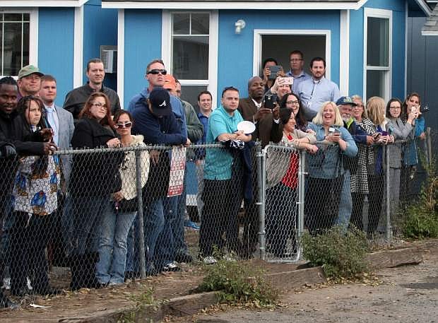 Reno residents wait to get a glimpse of Democratic presidential candidate Hillary Rodham Clinton after she toured Crossroads an Substance Abuse Facility sponsored by Catholic Charities of Northern Nevada Monday, Nov. 23, 2015, in Reno, Nev/ (AP Photo/Lance Iversen)