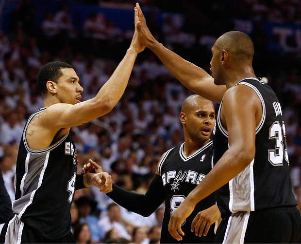 From left, San Antonio Spurs&#039; Danny Green, Patty Mills, and Boris Diaw celebrate during the second half against the Oklahoma City Thunder in Game 6 of the Western Conference finals NBA basketball playoff series in Oklahoma City, Saturday, May 31, 2014. (AP Photo/Sue Ogrocki)