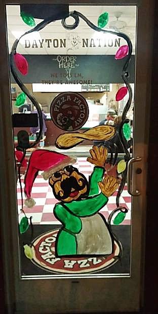 Dayton High School art students decorated windows of local businesses, including Pizza Factory, to help raise money for the Dayton High School Booster Club.