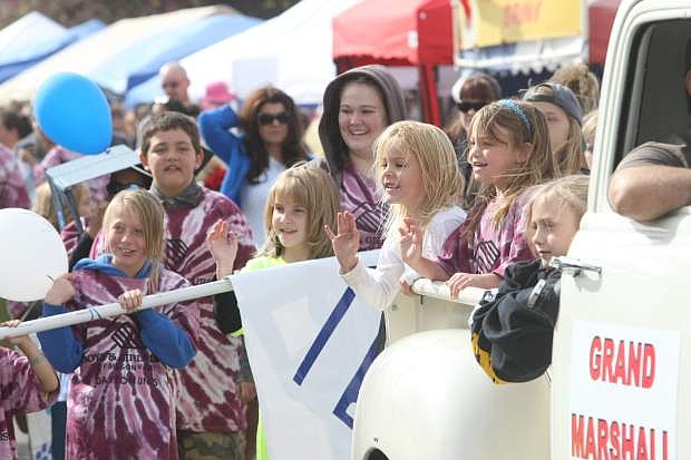 Children from the Boys &amp; Girls Club wave to the crowd during the parade on Saturday at Dayton Valley Days.