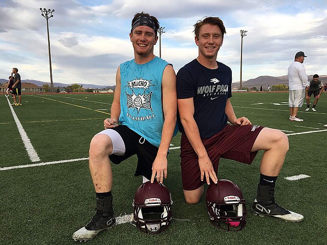 Jesse Schmidt, left, a senior, poses for a photo during practice Monday at Dayton High School with his younger brother, Justin Schmidt, a sophomore.