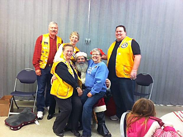 Last Saturday the Dayton Valley Lions and Silver Springs Lions, together with the Sullivan family, sponsored a Santa visit at the Silver Springs Community Center, where about 130 children saw Santa, received a stuffed animal and enjoyed hot chocolate and cookies. Pictured are some of the sponsors with Santa.