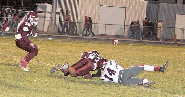 Elko&#039;s Adam Bullock recovers a fumble by Dayton&#039;s Davis Winebarger during Friday&#039;s game at Elko.
