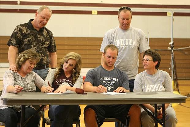 Makayla Shadle and Josh Koch sign their letters of intent on Wednesday at Dayton High School while parents, Michelle and Troy Shadle and Chris and Jim Koch look on.