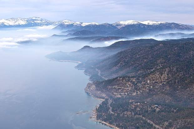 Cave Rock, the east shore, and a controlled burn is seen from high above Lake Tahoe on Wendesday during a scenic tour courtesy of Pilot Moe Makowski and Carson Aviation Services.For more photos, see page A5.