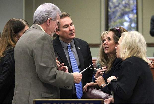 Nevada Assembly Republicans, from left, Shelly Shelton, Glenn Trowbridge, Brent Jones, Jill Dickman, Victoria Seaman and Victoria Dooling talk on the Assembly floor at the Legislative Building in Carson City, Nev., on Friday, May 22, 2015. Lawmakers work Friday to vote dozens of bills out of the Senate and Assembly as they face down a major deadline. (AP Photo/Cathleen Allison)