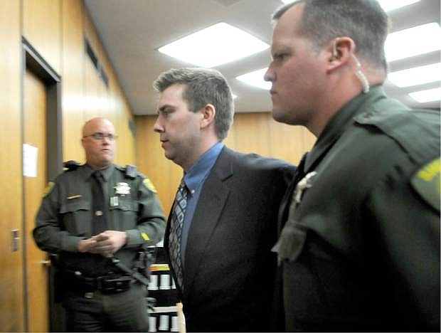 FILE  - In this June 2, 2010 file photo, James Biela is led from the courtroom in Reno, Nev. A jury sentenced Biela to death for raping and killing a college coed after sexually assaulting two others in a string of attacks that had the city of Reno on edge for most of 2008. A lawyer for Biela  goes before a Washoe County judge next week in the latest attempt to overturn his convictions. (AP Photo/Marilyn Newton, Pool, File)