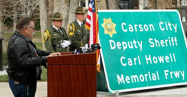 Kevin Howell, the father of Deputy Carl Howell gets emotional as he talks about his son during a freeway sign dedication ceremony on Tuesday.