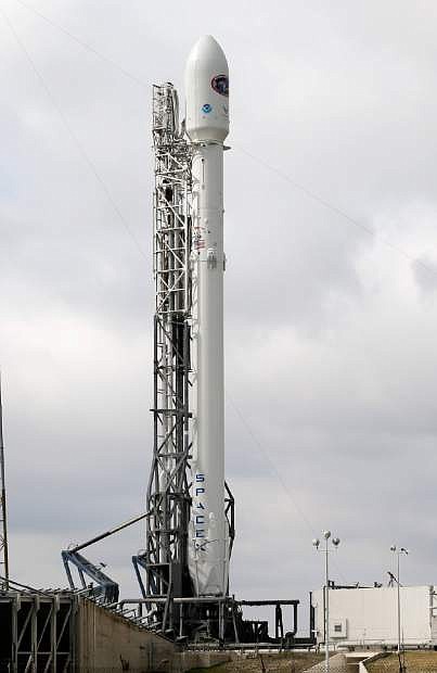 A Falcon 9 SpaceX rocket stands ready at  launch complex 40 at the Cape Canaveral Air Force Station in Cape Canaveral, Fla., Tuesday, Feb. 10, 2015. The rocket, after a Sunday scrub, will make its second launch attempt this evening.  (AP Photo/John Raoux)