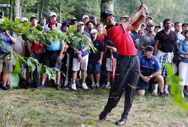 Tiger Woods hits out of the rough on the 12th hole during the final round of the Deutsche Bank Championship golf tournament in Norton, Mass., Monday, Sept. 2, 2013. (AP Photo/Michael Dwyer)