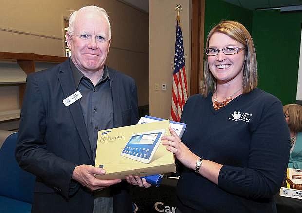 Supervisor John McKenna presents Sena Loyd with a Galaxy Tablet to kick off a digital device donation drive at the grand opening of the Digitorium on Oct. 23 at the Carson City Library.