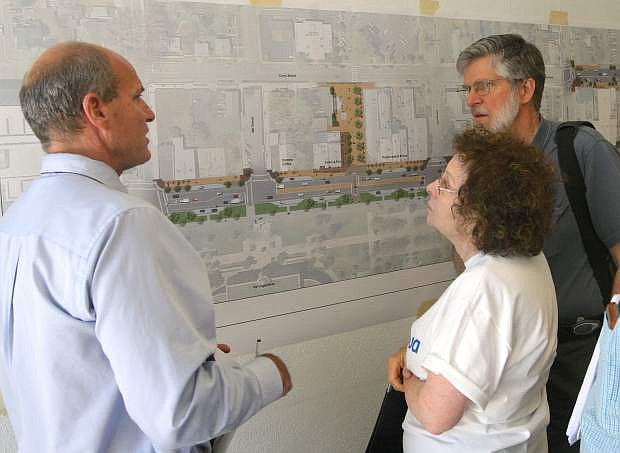 Steve Noll, left, of Design Workshop talks with Carson City residents David and Elinor Bugli about the downtown improvement plan on Monday.