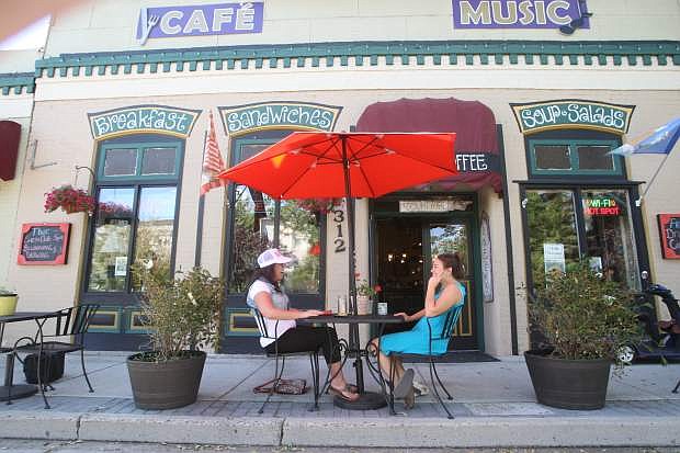 Morgan Howard, left, and Chantel Good dine in front of Comma Coffee on Monday. The outdoor seating was recently added after the removal of fencing along Carson Street. A planning group is recommending more changes for downtown Carson City.