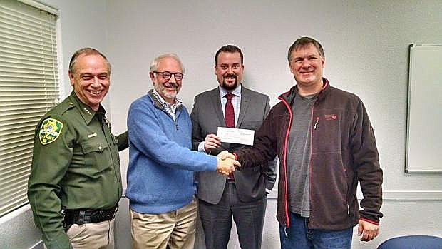 From left: Sheriff Ken Furlong; Michael Sharp, vice president, Bank of America; Chris McQuattie, Bank of America and Dr. Robert Fliegler, board president Community Counseling Center accepting the check from Bank of America.