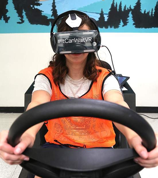 Carson High School student Trinity Vullock, 15, drives in a virtual reality program that simulates texting and driving and the consequences of doing so.