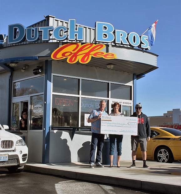Kurt Meyer, president of the Boys &amp; Girls Clubs of Western Nevada board of directors, and Katie Leao, chief professional officer for the club, receive a $1,300 check from Andy Head, owner of Dutch Bros. Coffee on Carson Street, on Thursday. The coffee house pledged to donate $1 for each beverage sold on Dec. 4 to the Boys &amp; Girls Clubs of Western Nevada.