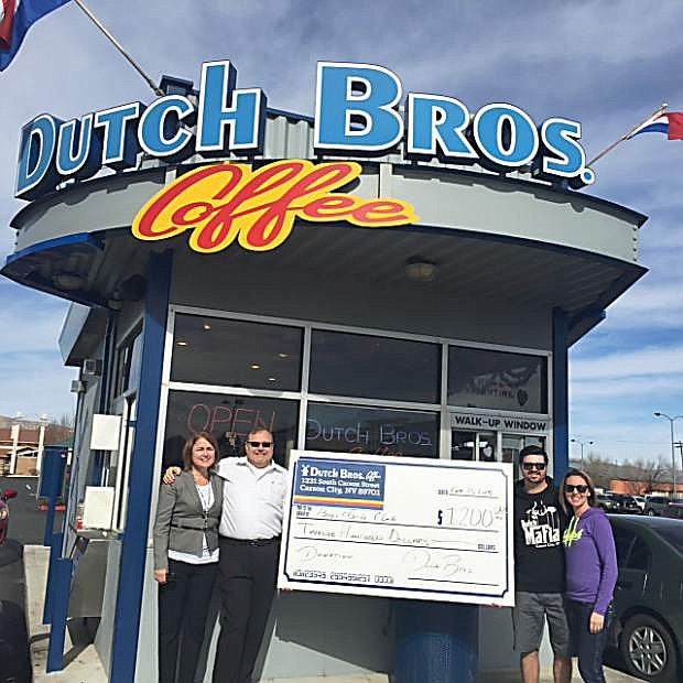 Carson City Dutch Bros. owners Andy and Jill Head, shown on the right, present a $1,200 check to Laurie Gorris, chief professional officer, and Cliff Sorensen, board member, of Boys &amp; Girls Clubs of Western Nevada.