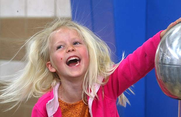 Rachel Girdner, 7, enjoys a hair-raising experience at the Eagle Valley Middle School STEAM event on Tuesday night.