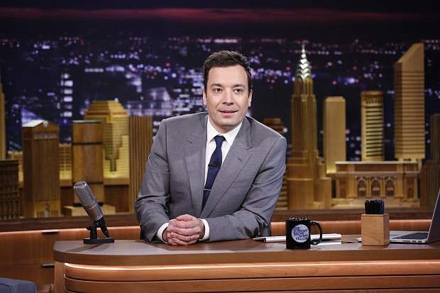 FILE - In this Feb. 17, 2014 file photo provided by NBC, Jimmy Fallon appears during his &quot;The Tonight Show&quot; debut, in New York. Comcast&#039;s first-quarter net income rose by nearly a third as ad revenue surged at broadcast network NBC, helped by the Winter Olympics in Sochi and Fallon&#039;s elevation as host of &quot;The Tonight Show.&quot; (AP Photo/NBC, Lloyd Bishop, File)