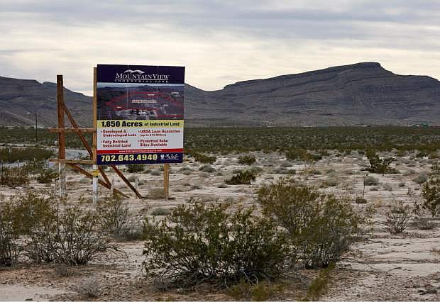 A sign advertises Mountain View Industrial Park near Apex Industrial Park on Wednesday, Dec. 9, 2015, in North Las Vegas, Nev. Chinese-backed electric carmaker Faraday Future plans to build a manufacturing plant near the site, according to a letter the company sent Nevada officials Wednesday. (AP Photo/John Locher)