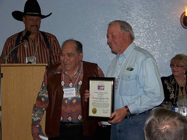 Tom Zogorski accepts the Veteran Volunteer Award from State Elks Veterans Chairman Pete Urdiales, Jr. while State Elks President Lee Butts looks on at the Nevada State Elks Association Convention in Hawthorne.