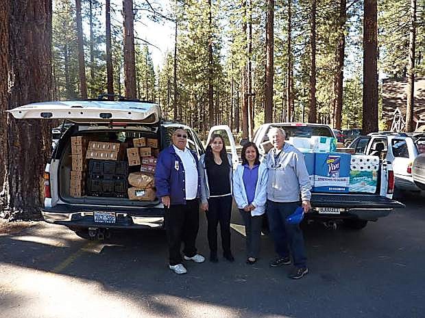 Members of Tahoe-Douglas Elks Lodge 2670 and Live Violence Free accept food and other supplies from the Northern Nevada Food Bank truck at Zephyr Cove to transport to the Live Violence Free facility in South Lake Tahoe. The food, collected monthly, is distributed to the needy clients, usually victims of sexual assault or family abuse, of Live Violence Free.