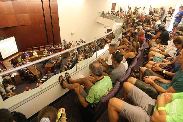 Participants in the Tahoe Rim Trail Endurance Run listen during a pre-run briefing at the Legislature on Friday afternoon.