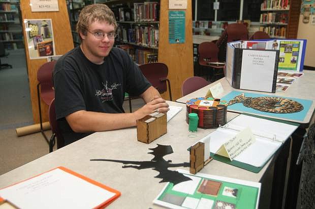 Senior Jason Thorsen displays holders for business cards and poker chips Wednesday evening, a project for his CADD 2 class at CHS.