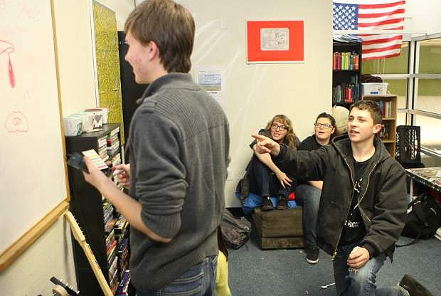 Sixteen-year-old Jake Fenzke, 15-year-old Cameron Junger, 16-year-old Chelsea Phillips and 17-year-old Alyssa Sisson play Pictionary in the teen center of the Boys &amp; Girls Clubs of Western Nevada on Friday afternoon.