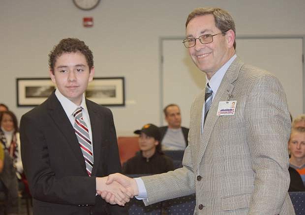 Carson City Superintendent Richard Stokes shakes hands with the 2015 American Citizen Essay Contest from the high school level, Alan Moises Fernandez Garcia at the school board meeting Tuesday. Garcia is a 9th grader at Carson High School.