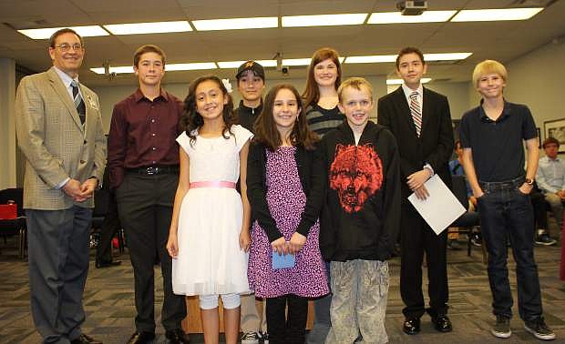 Carson City Superintendent Richard Stokes stands with the winners from the 2015 American Citizen Essay Contest at the school board meeting Tuesday night. Three winners from the elementary, middle and high school levels were selected for their essays.