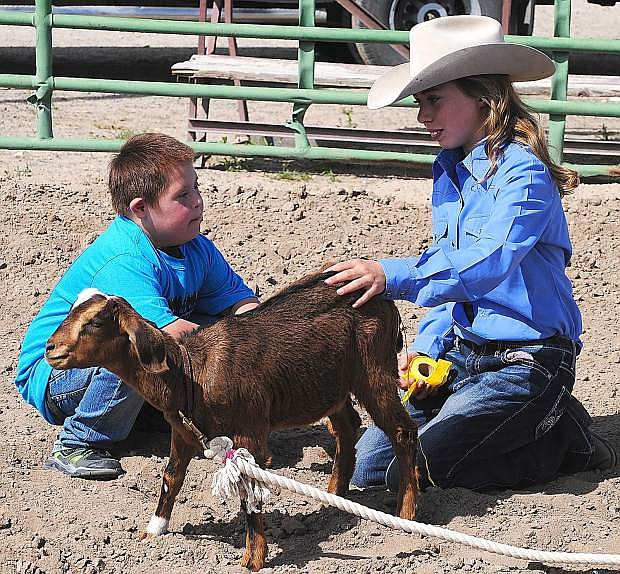 Kenrich Welch, left, learns how to undecorate a goat from sixth-grader Chloe Lambert during Friday&#039;s Exceptional Rodeo at the Churchill County Fairgrounds.