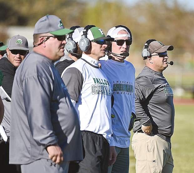 Fallon coach Brooke Hill, far right, assesses a game situation during a Greenwave football game. From left are coaches Matt Hyde, Pat Squires, Tom McCormick, Ryan McCormick and Hill.