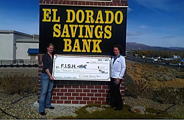Kara Levario, Vice President and Branch Manager of the Carson City branch of the El Dorado Savings Bank, presents a check for $1,000 to Kelsey Poole, development associate at Friends in Service Helping, or FISH.