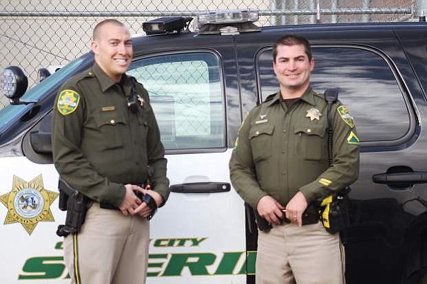 Carson City Deputies Jonathan Stone and Matt Smith pose in front of their patrol car. Stone is training to be a patrol deputy with the Sheriff&#039;s Department and Smith is his Field Training Officer for the first phase of training.